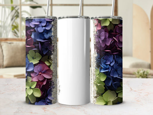 White tumbler with colorful floral design and silver glitter accents.