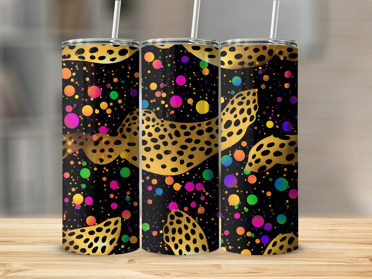 Three tumblers with a black, gold leopard print, and colorful polka dot design.