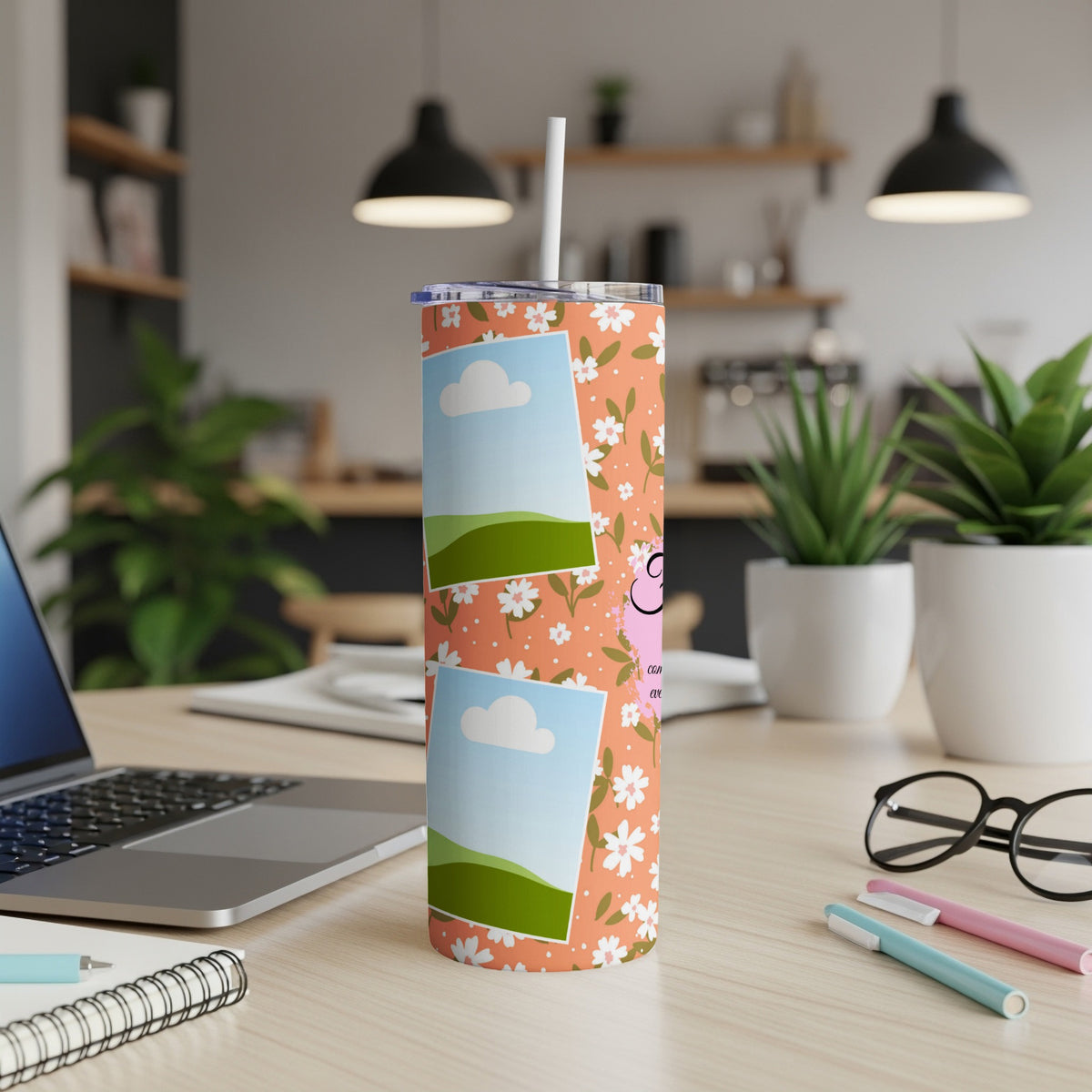 Tumbler with floral pattern and photo placeholders on a desk.