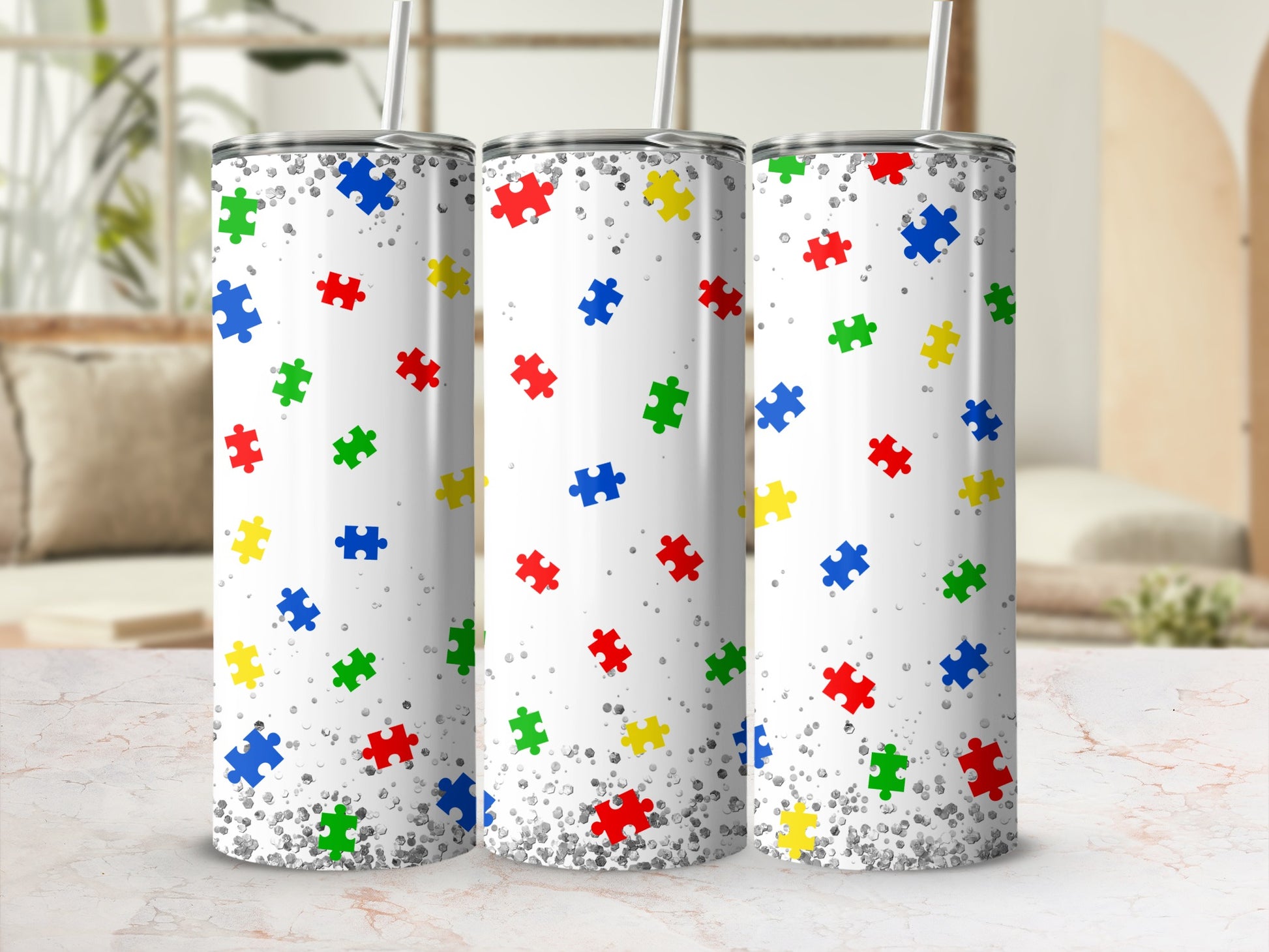 Three white tumblers with a colorful scattered puzzle piece pattern.