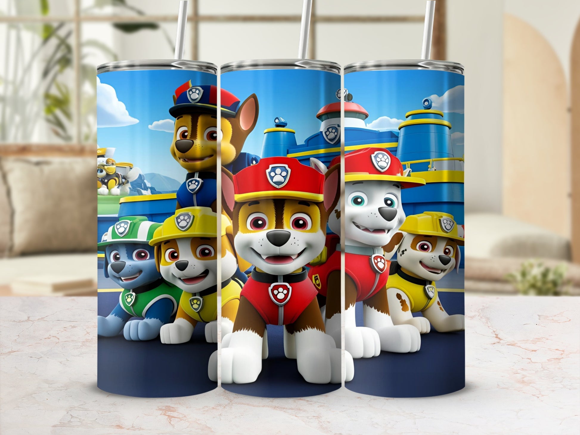 Paw Patrol characters Chase, Marshall, and Rubble on a blue tumbler with straw.