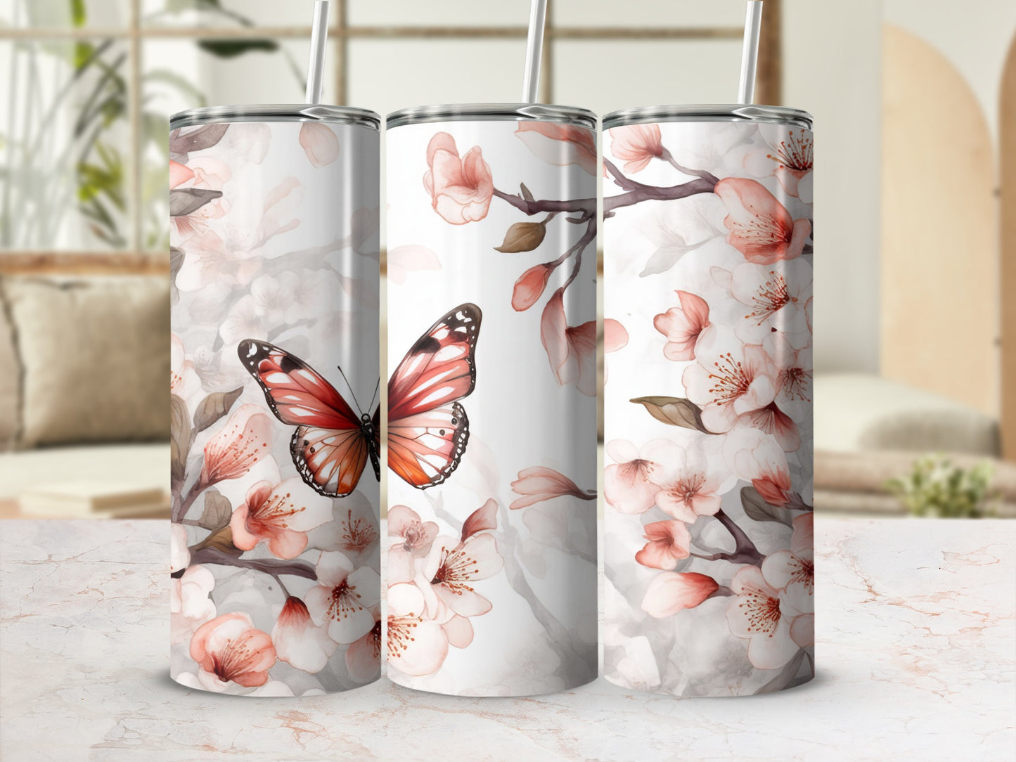 Three tumblers featuring a butterfly and blooming cherry blossoms.