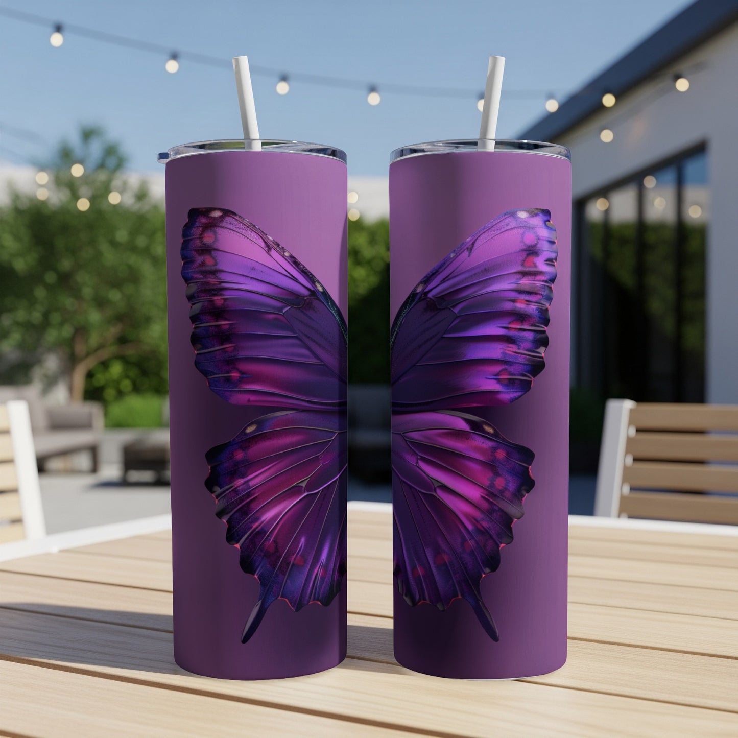 Purple butterfly wings design on two slim tumblers with straws.