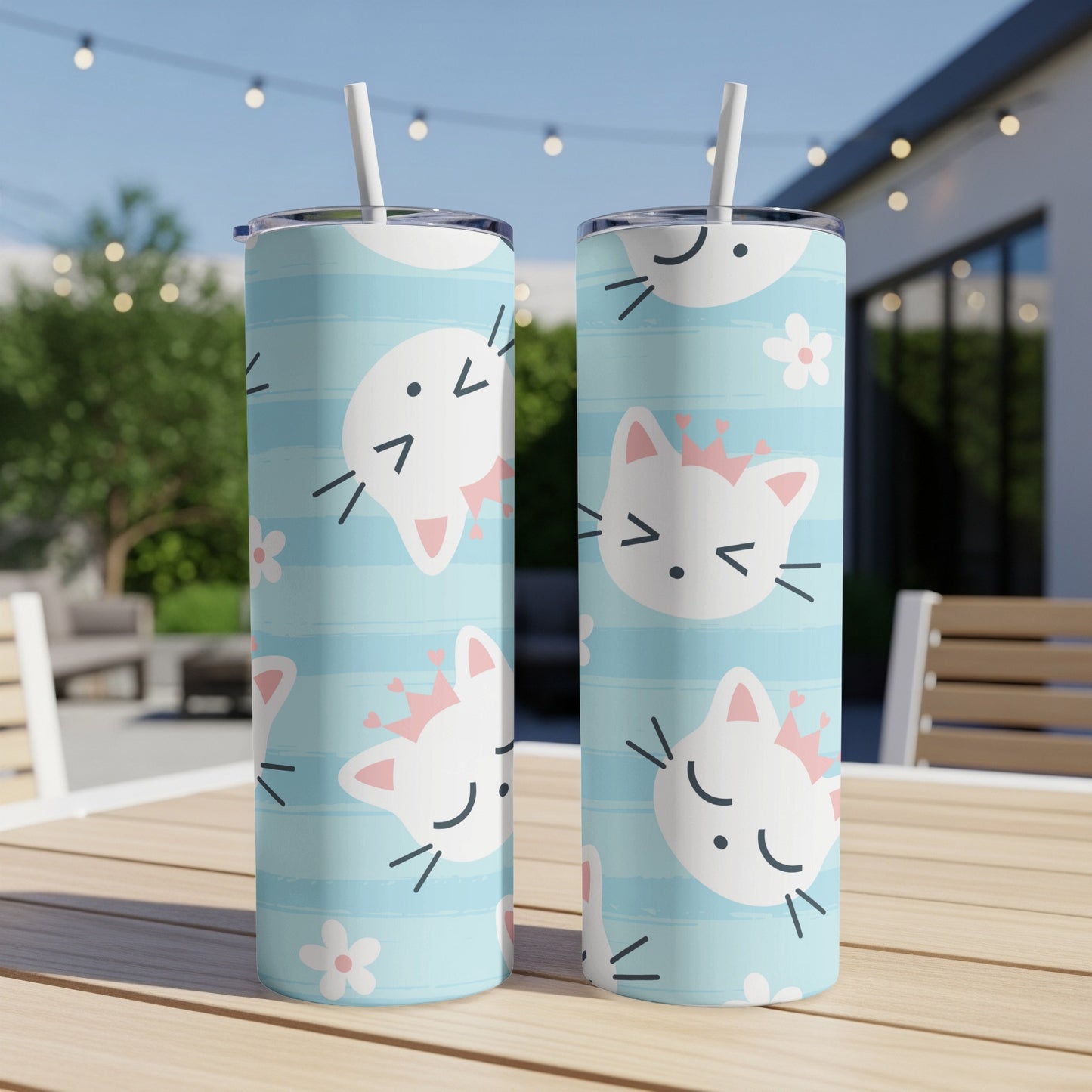 Two tumblers with a blue striped pattern and white cat faces wearing pink crowns.