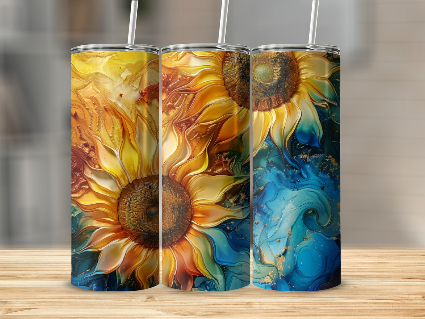 Three tumblers with vibrant sunflower and abstract blue and yellow designs.