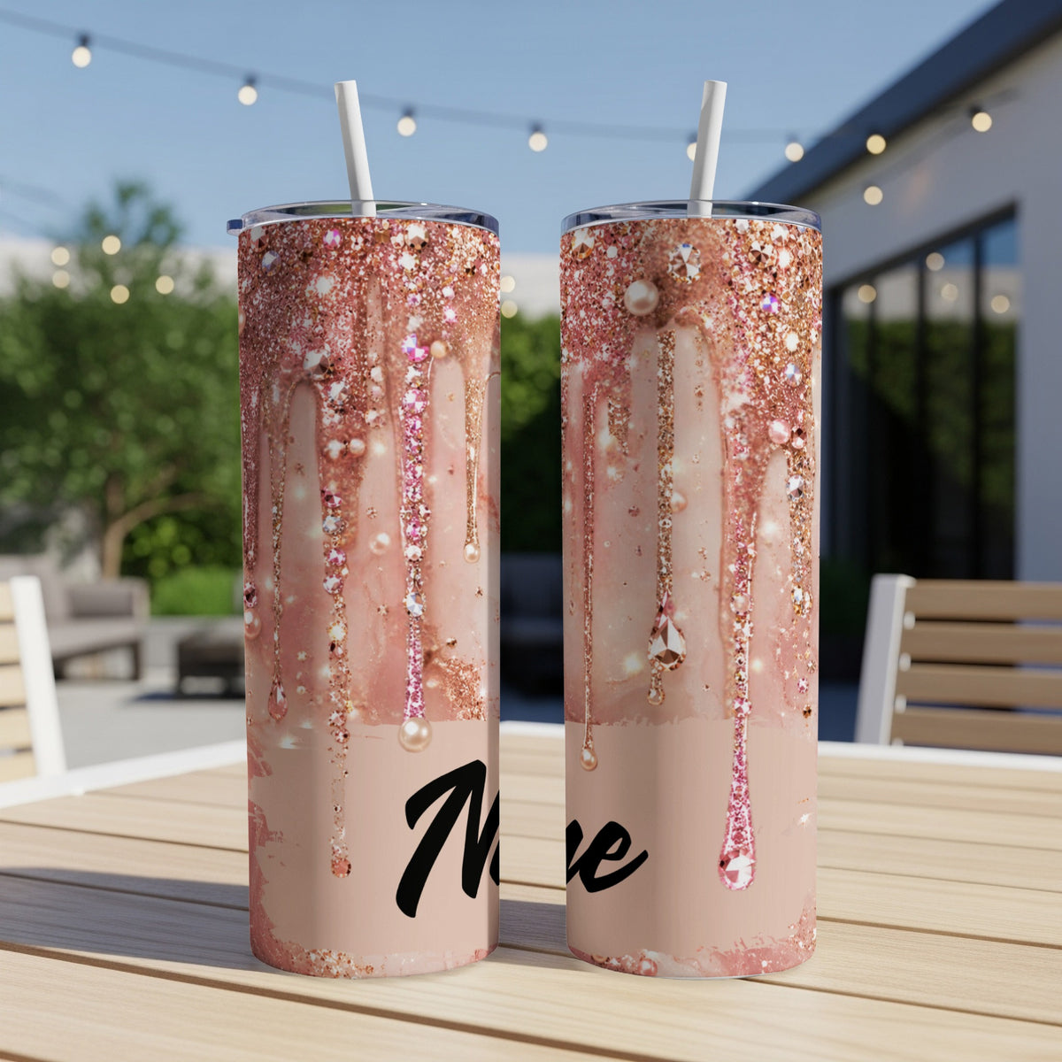 Two rose gold glitter tumblers with "More" text, set on a wooden table.