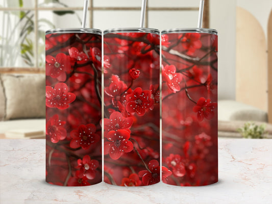 Red floral pattern on a set of three stainless steel tumblers.