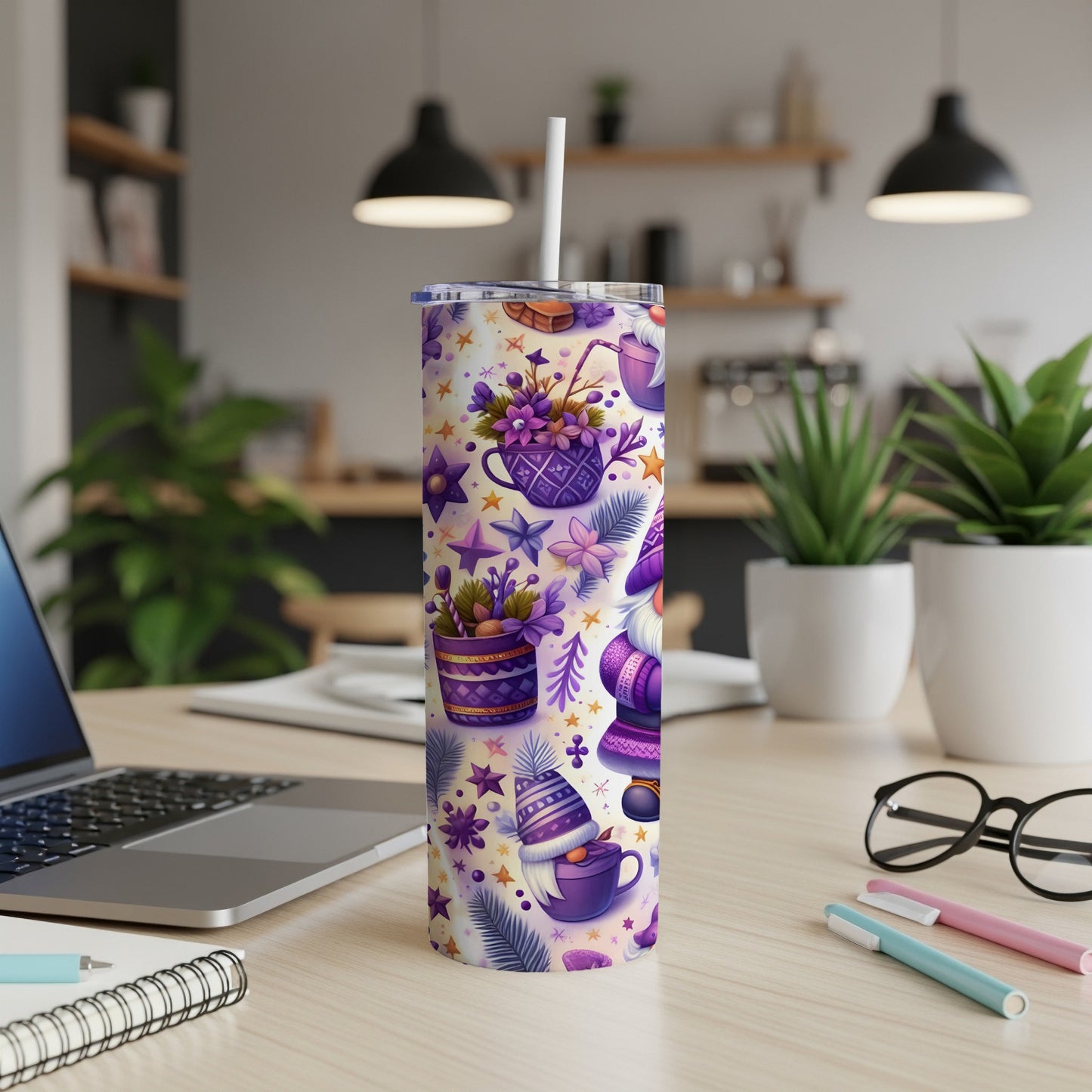 Purple and white patterned tumbler with cups, hats, and stars on a desk.