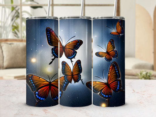 Three tumblers with orange and blue butterflies on a starry background.