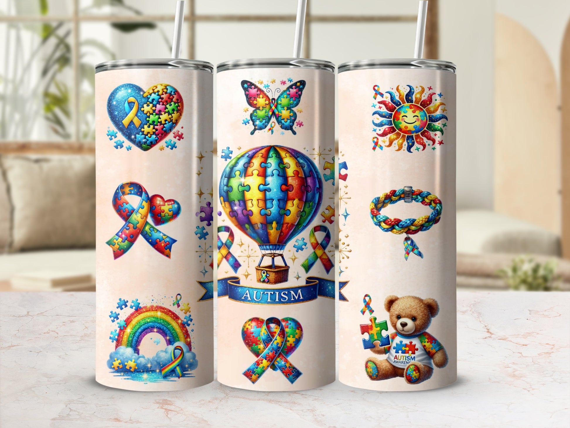 Autism awareness tumbler with puzzle pieces, butterfly, rainbow, and teddy bear.