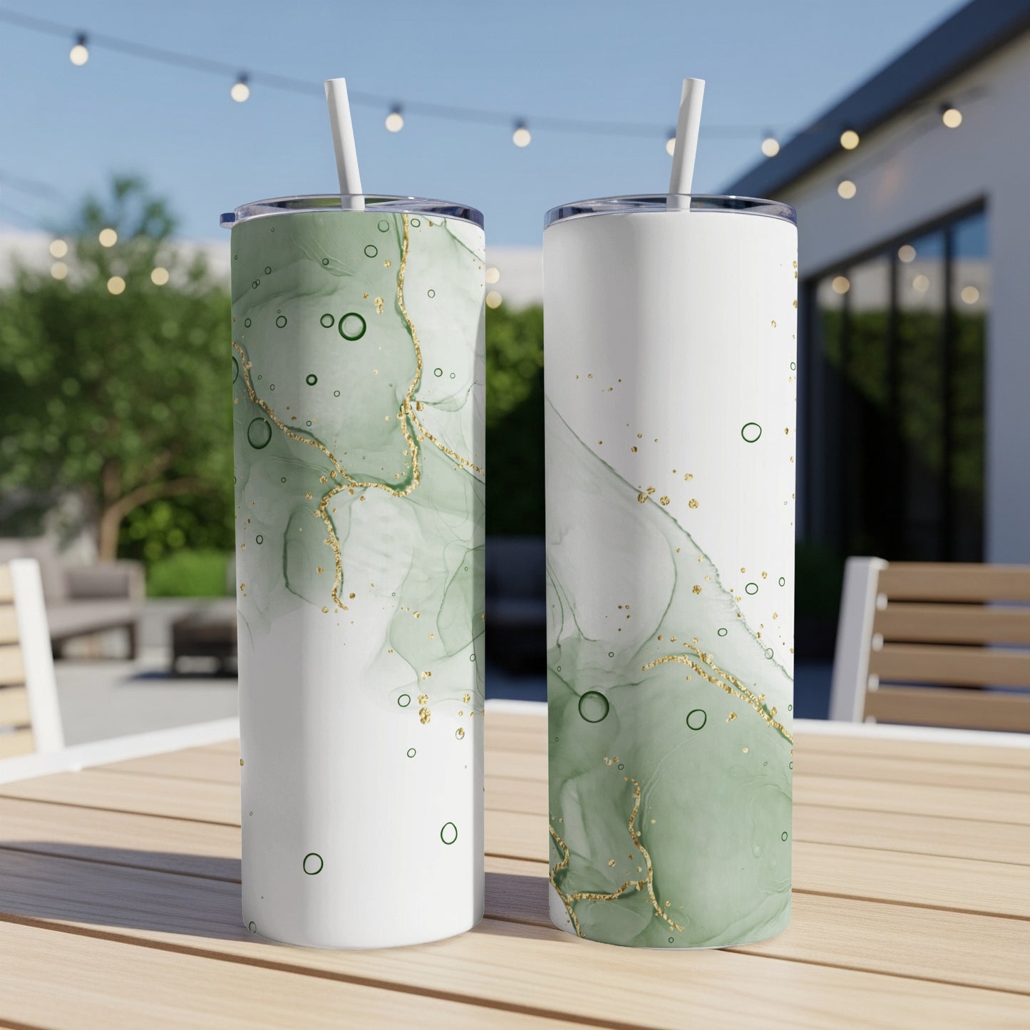 Two white tumblers with green marble design and gold specks.