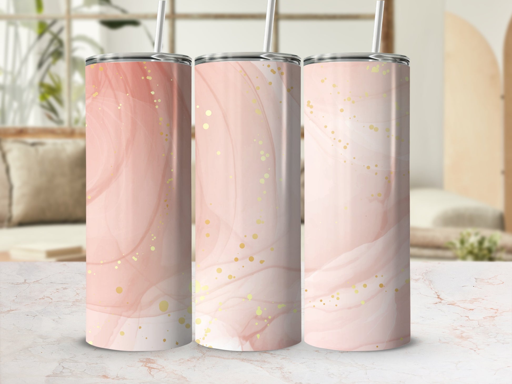 Three pink abstract marbled tumblers with gold glitter accents and straws.