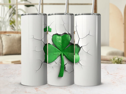 Three white tumblers with cracked texture revealing a green shamrock.