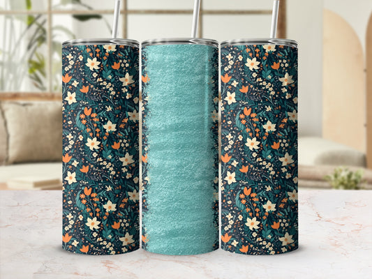 Floral tumbler with teal texture on marble background.
