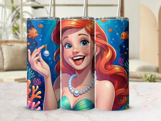 Ariel the mermaid holds a pearl necklace, surrounded by colorful coral and fish.