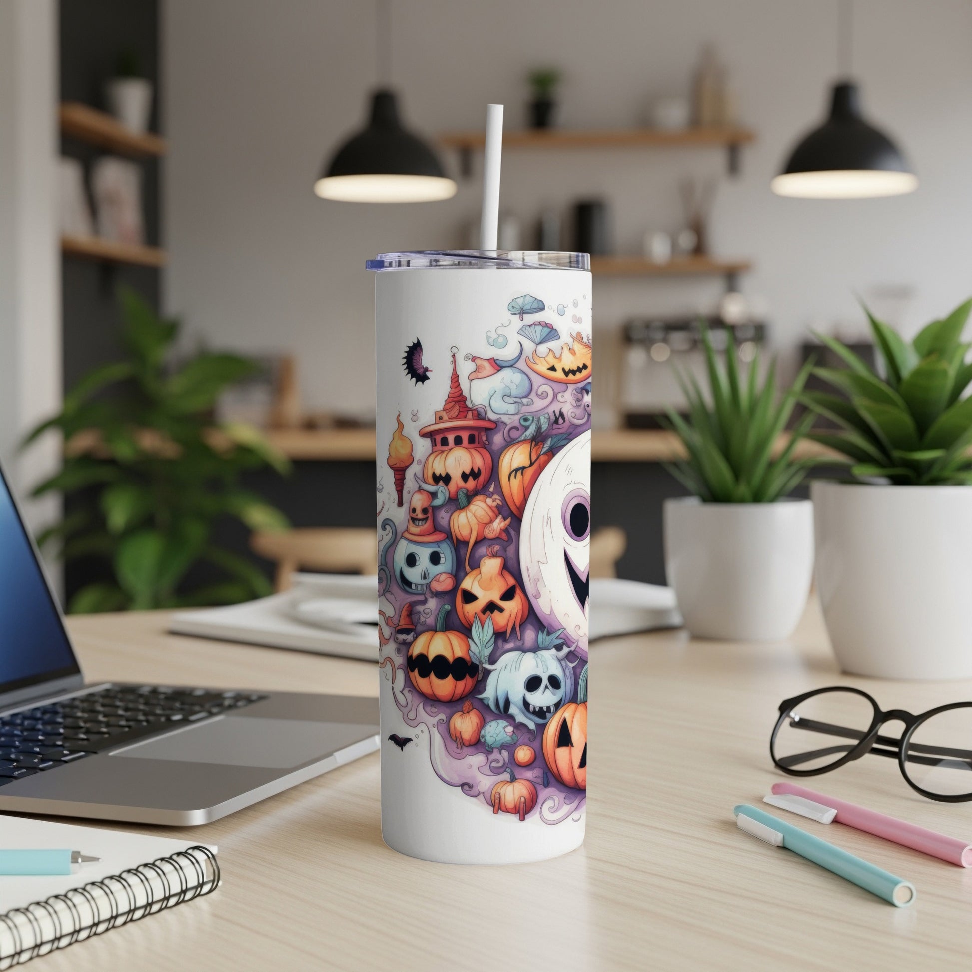 White tumbler with assorted cartoon pumpkins and ghosts for Halloween.