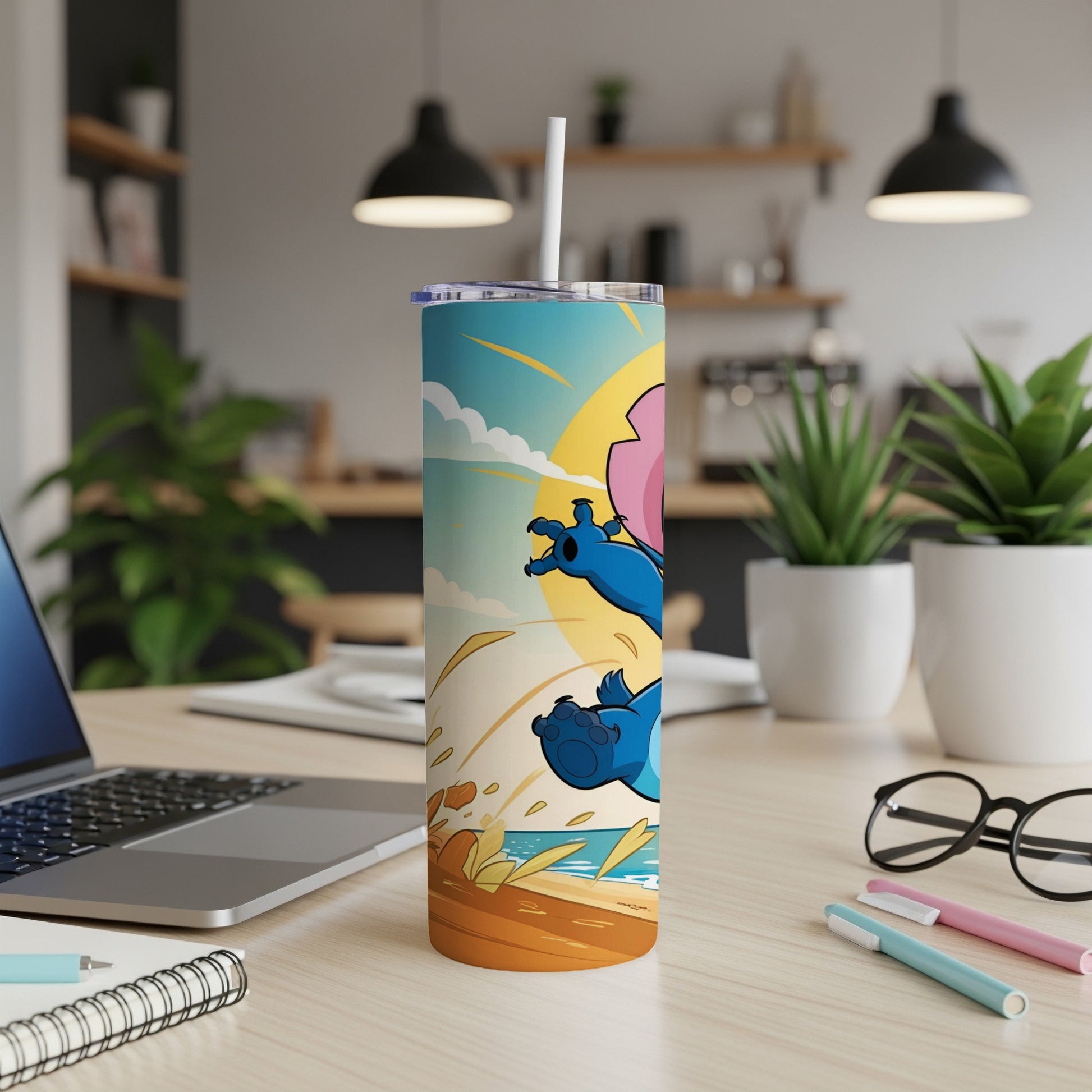 Blue alien character reaching for pink object on beach with laptop on desk.