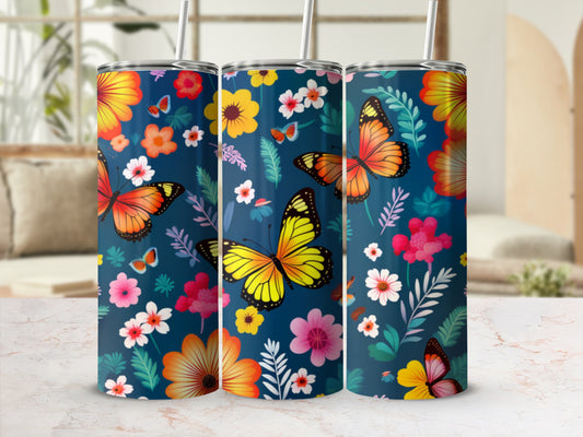 Three tumblers with a navy background, featuring orange and yellow butterflies and colorful floral patterns.