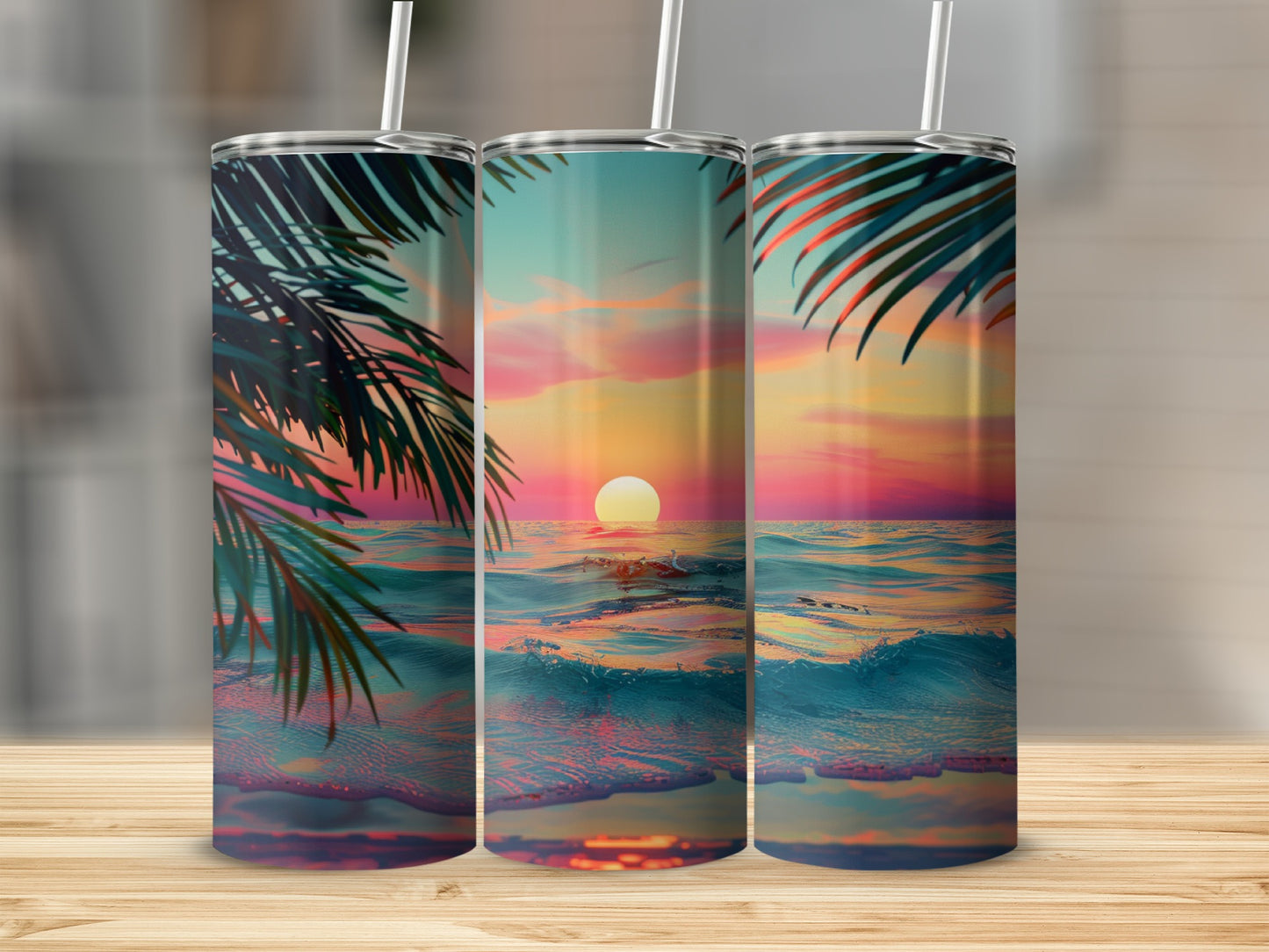 Three tumblers with a tropical sunset beach scene on a wooden surface.