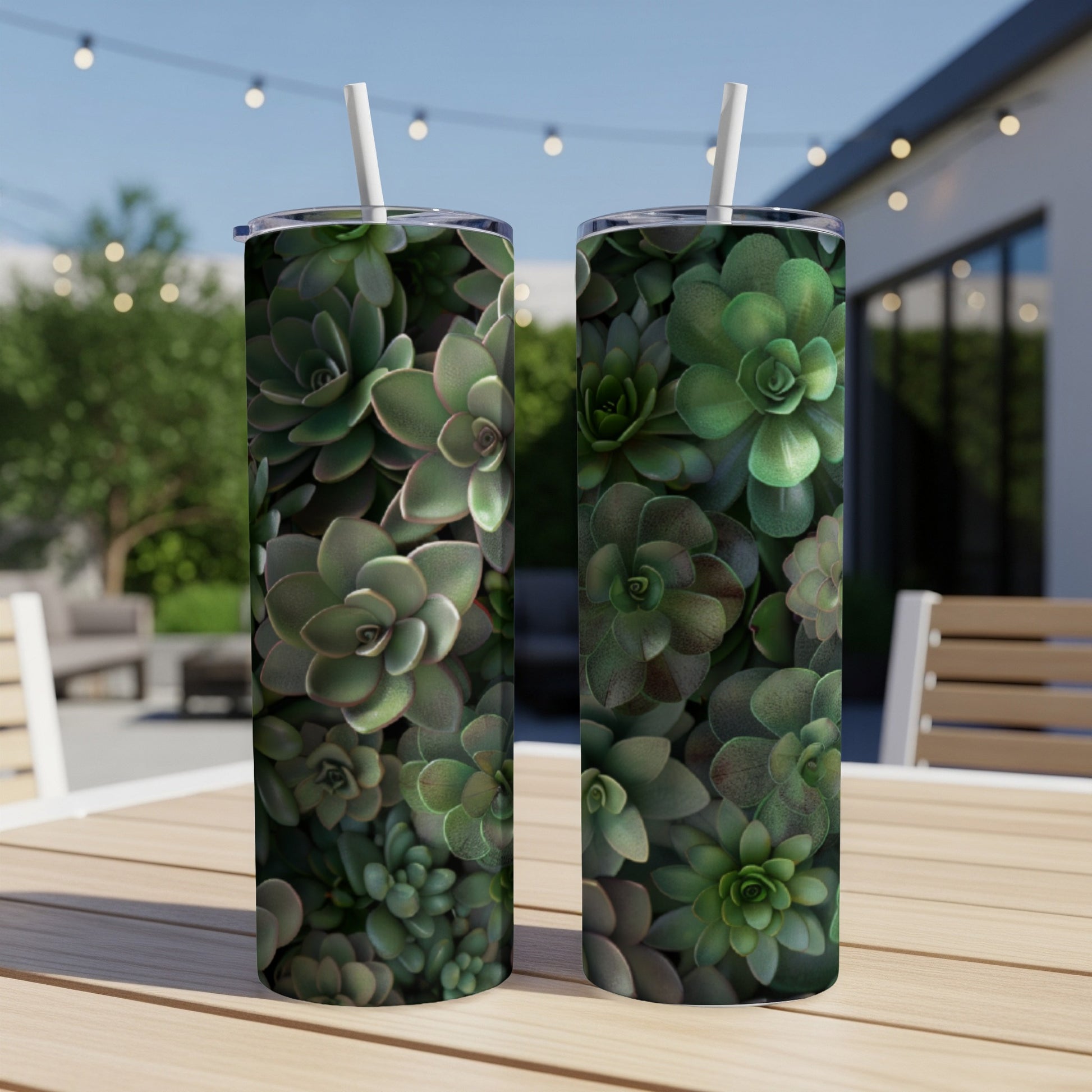 Two tall tumblers with a succulent plant pattern on a patio table.