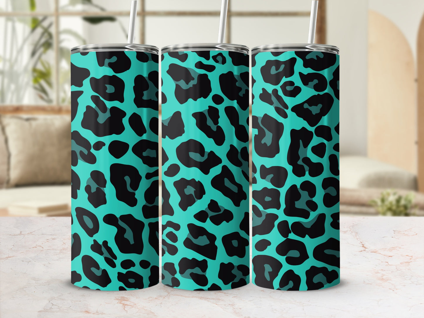 Three teal tumblers with black leopard print, each with a straw.