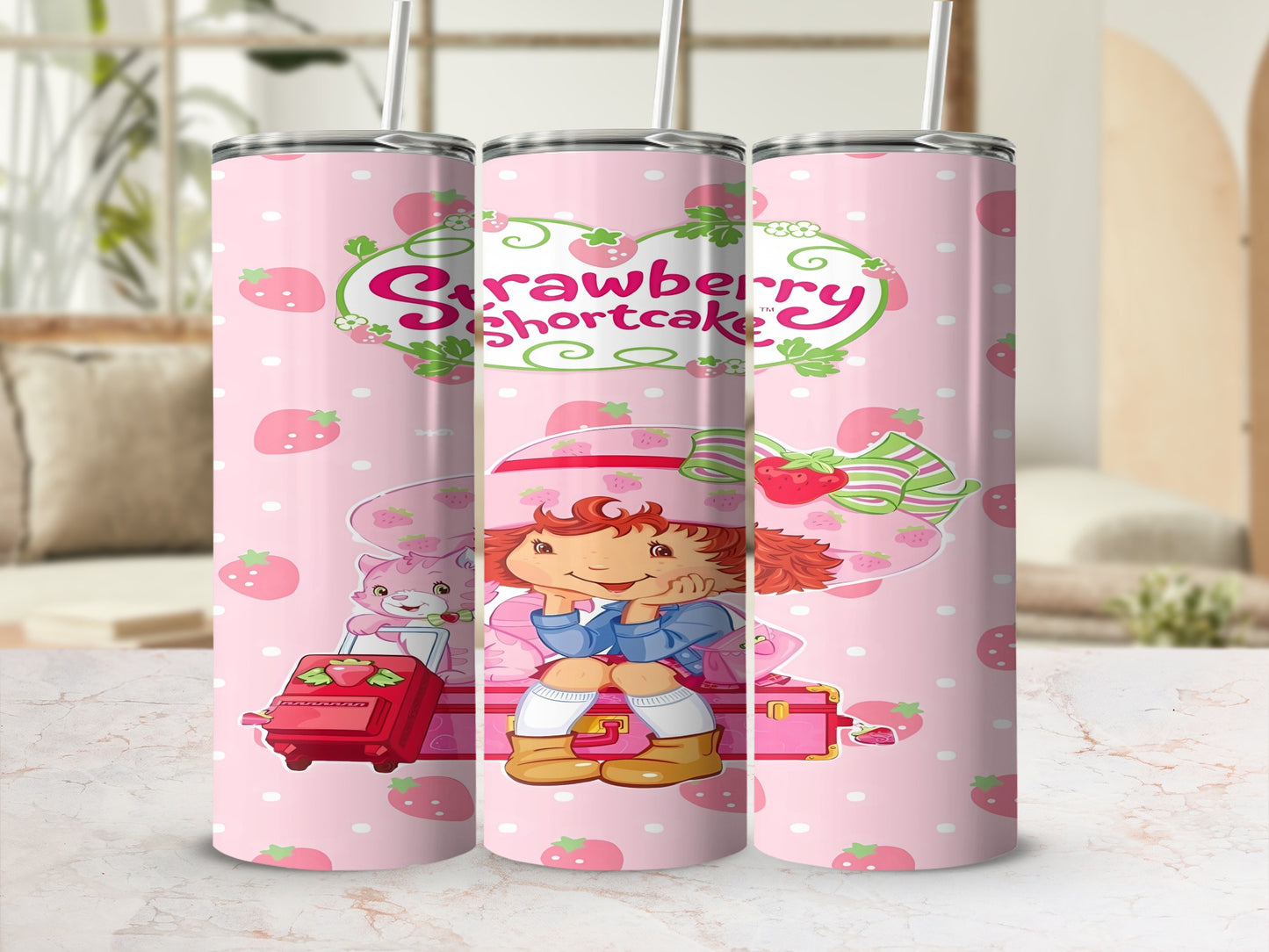 Strawberry Shortcake character sitting on pink luggage, surrounded by strawberries.
