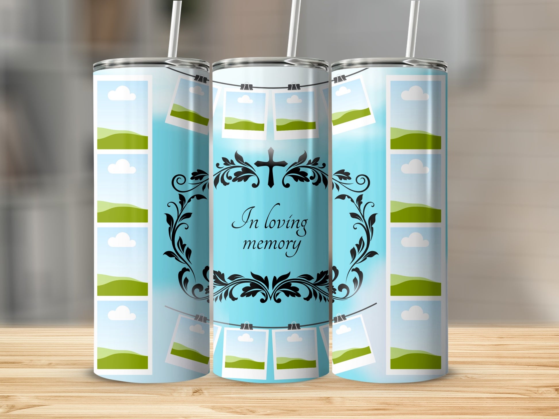 Three tumblers with a sky blue background and a cross with "In loving memory" text.
