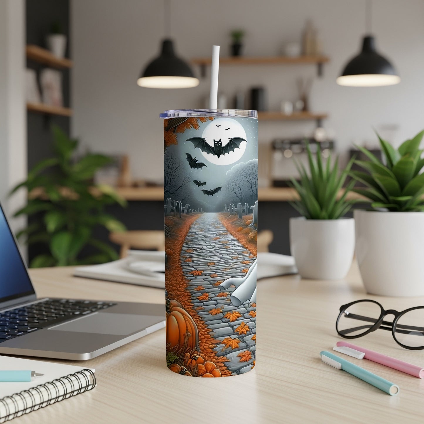 Halloween tumbler with bats, ghosts, pumpkins, and moon on a graveyard path.