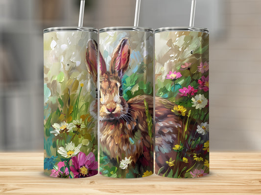 Three tumblers feature a painterly rabbit amidst colorful spring flowers.