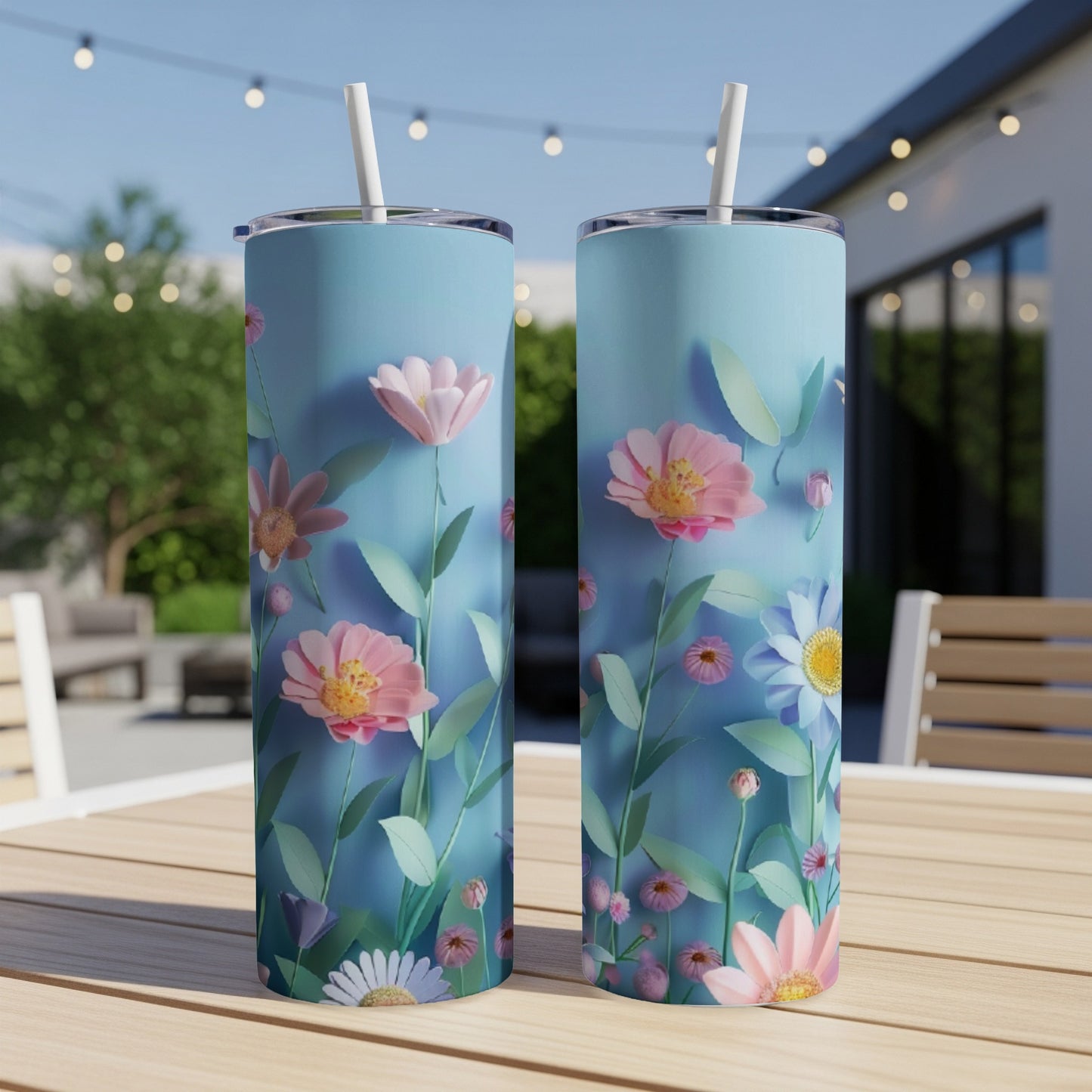 Two tall tumblers with a pastel floral design on a wooden table.
