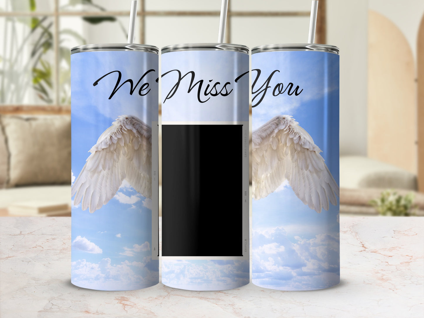Tumbler with angel wings, blue sky, clouds, and text "We Miss You".