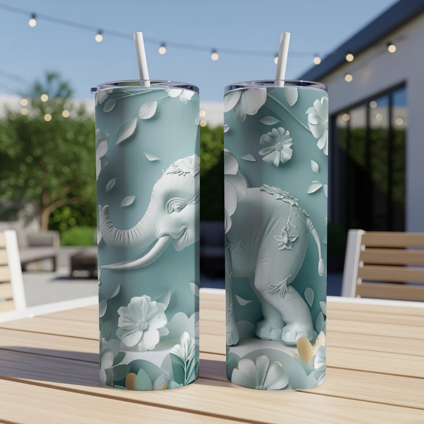 Two teal tumblers with embossed elephant and floral designs.