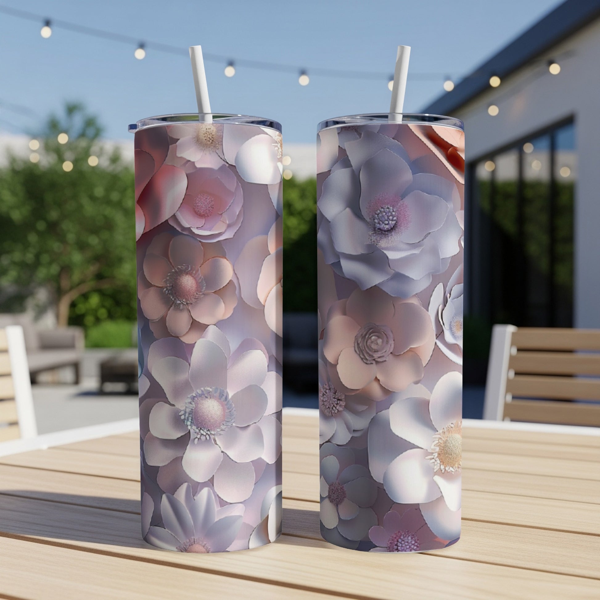Two tumblers with a floral pattern on a wooden table.