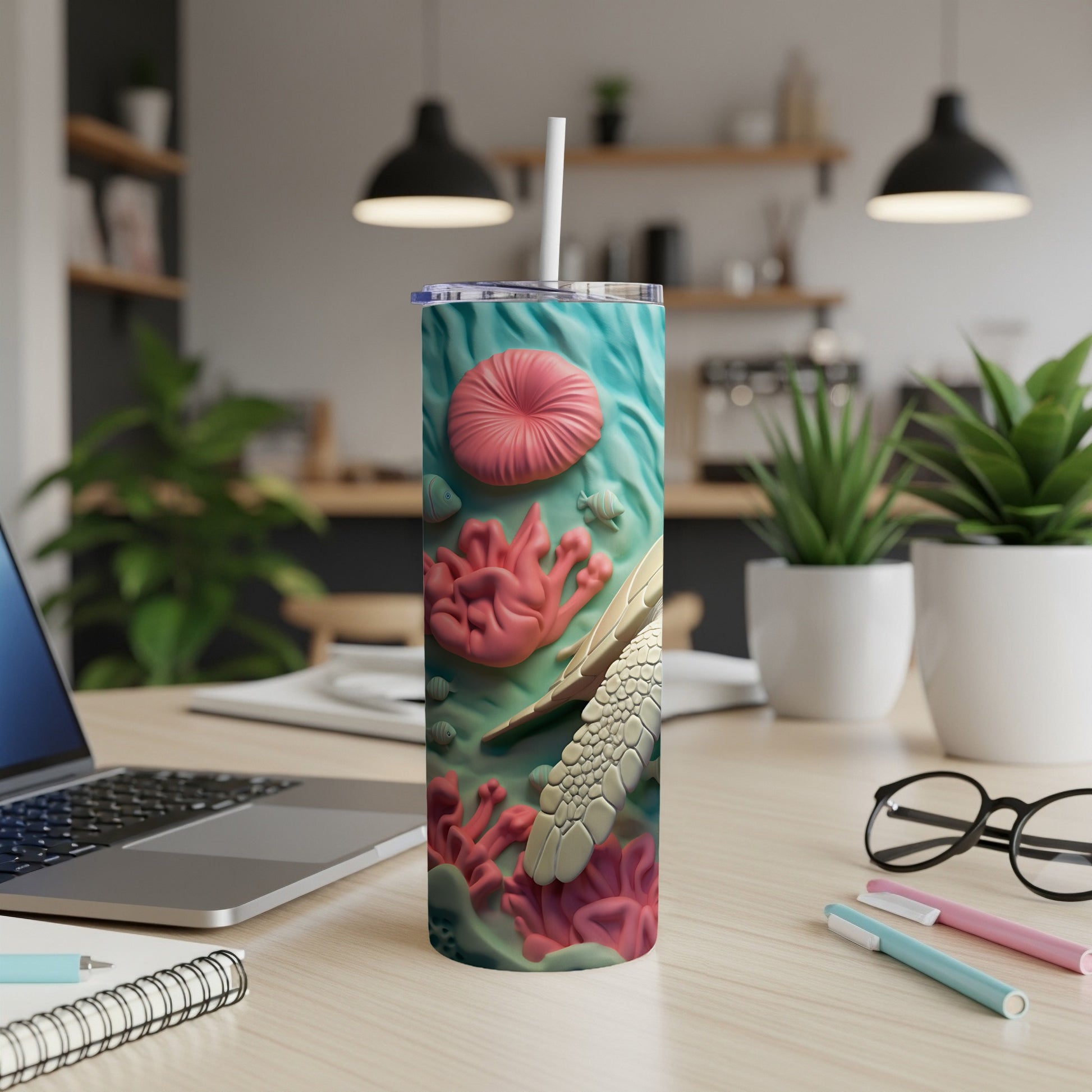 Turtle and coral reef design on a white tumbler with a straw.
