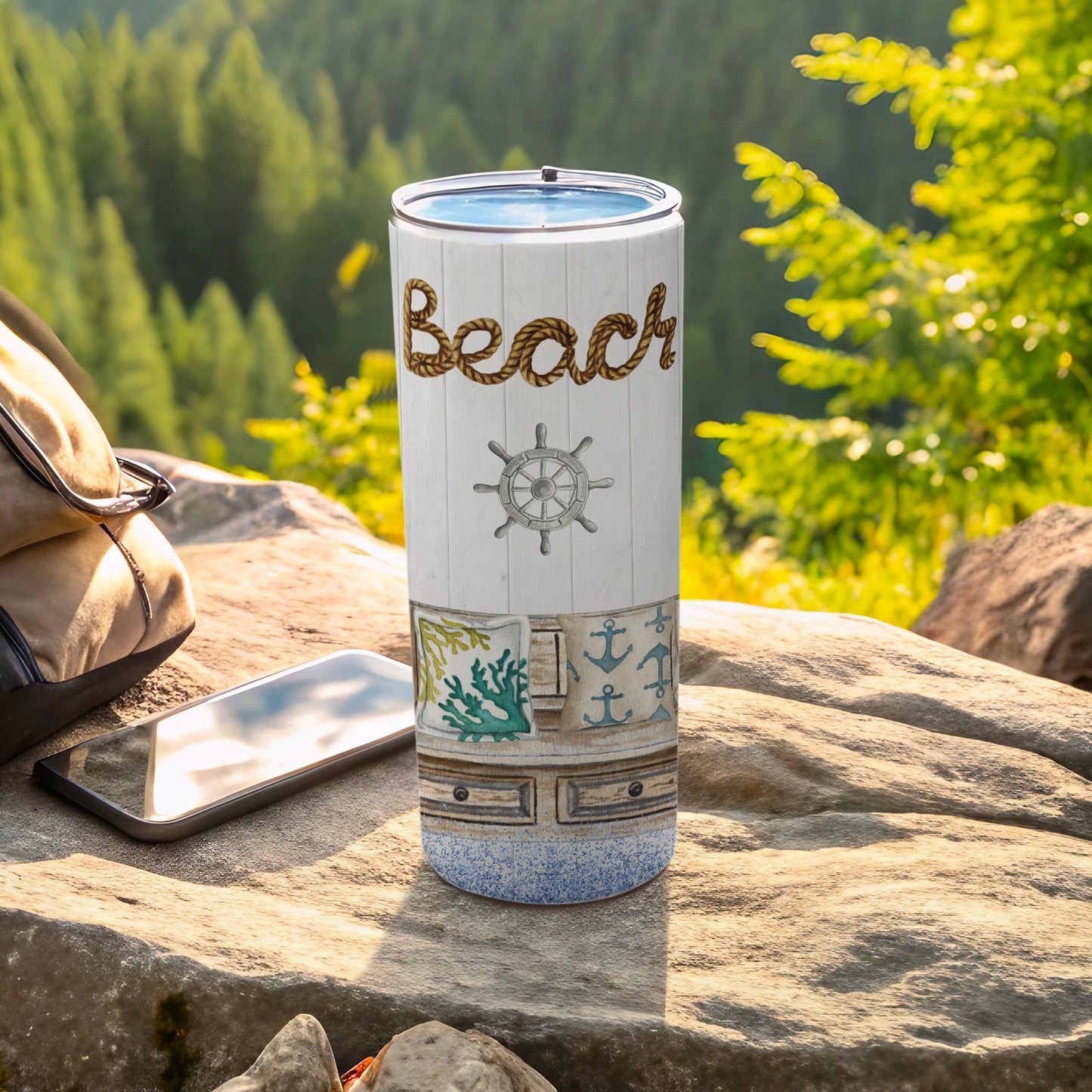 Beach-themed tumbler with rope lettering, nautical elements, and stone backdrop.
