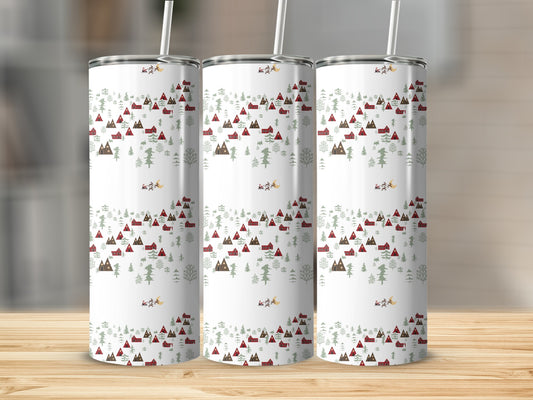Three insulated tumblers with a white background and a festive red and green Christmas village pattern.