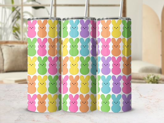 Three colorful bunny-patterned tumblers on a marbled surface.