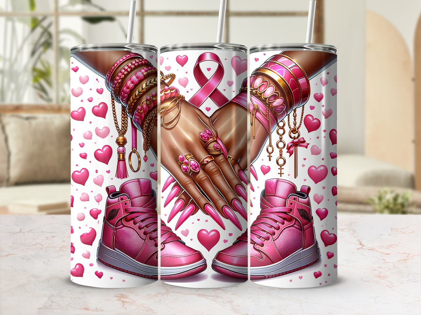 Pink breast cancer awareness tumbler with hands adorned with jewelry.