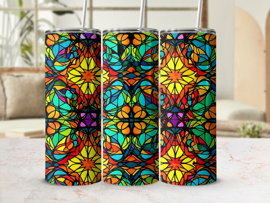 Three stained-glass tumblers with abstract, colorful geometric patterns.