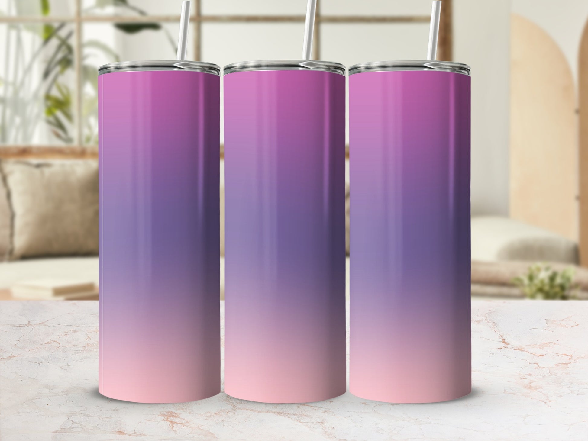 Three gradient tumblers with purple and pink ombre design, standing on a marble surface.