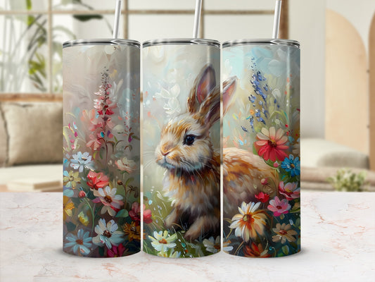 Tumbler with a rabbit and floral illustrations.