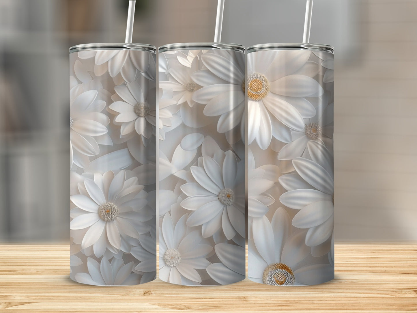 Three white daisy tumblers with straw on wooden surface.