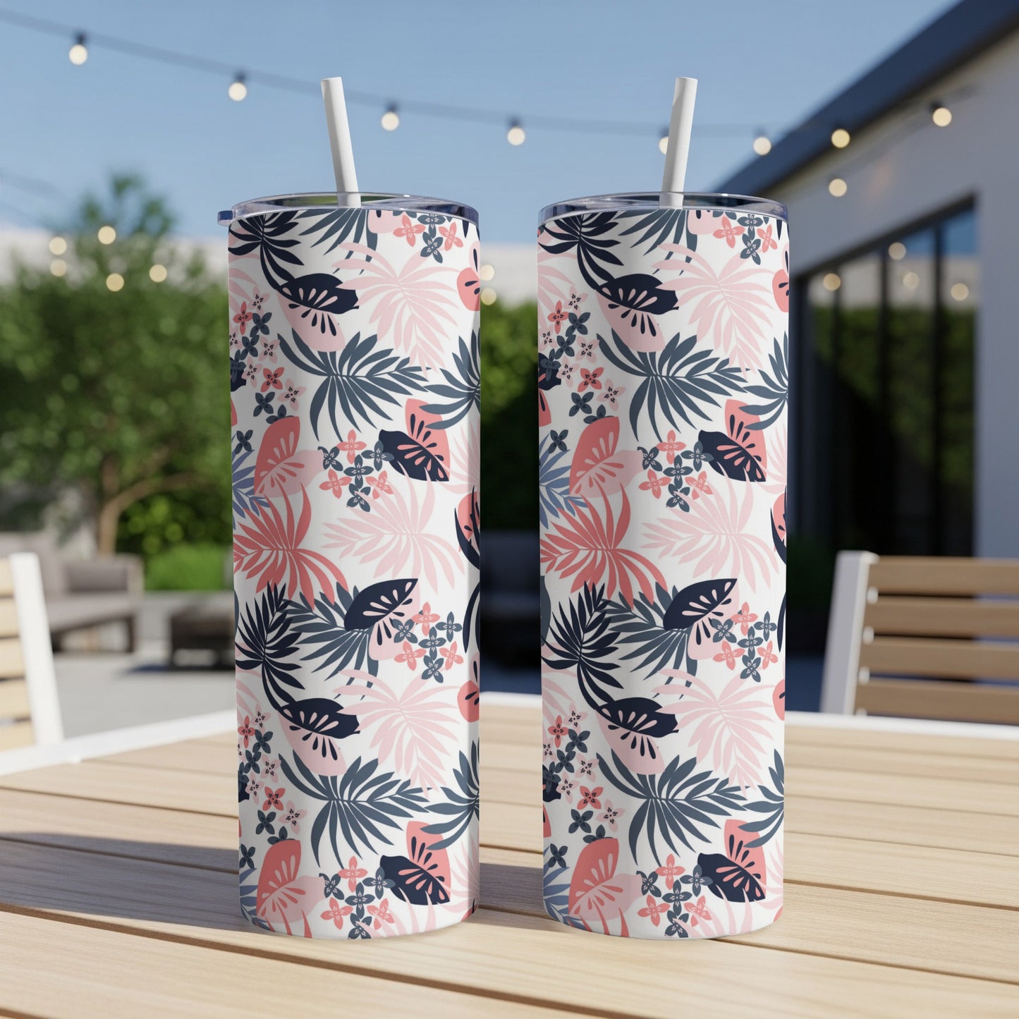 Two tall tumblers with a tropical leaf and floral pattern.