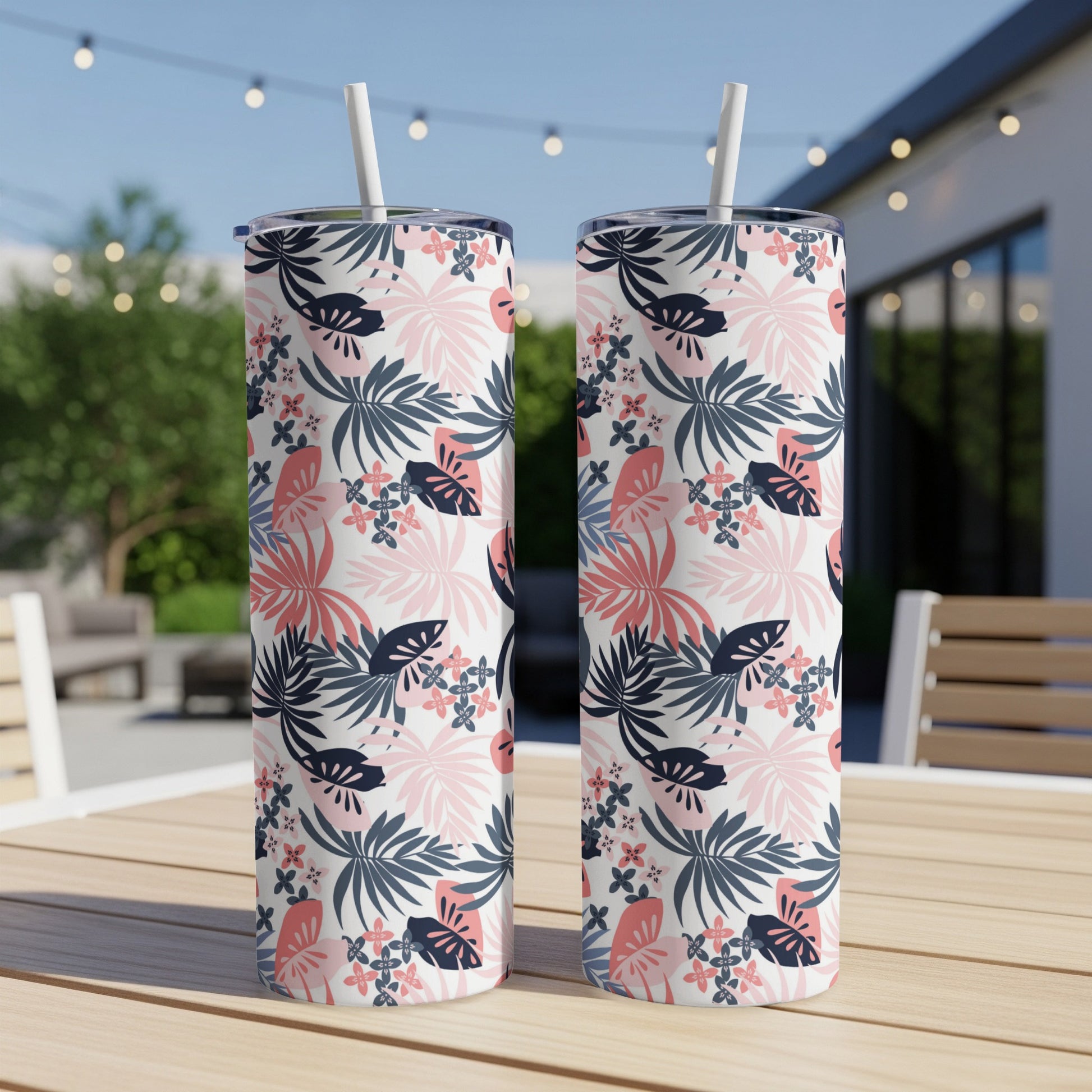 Two tall tumblers with a tropical leaf and floral pattern.