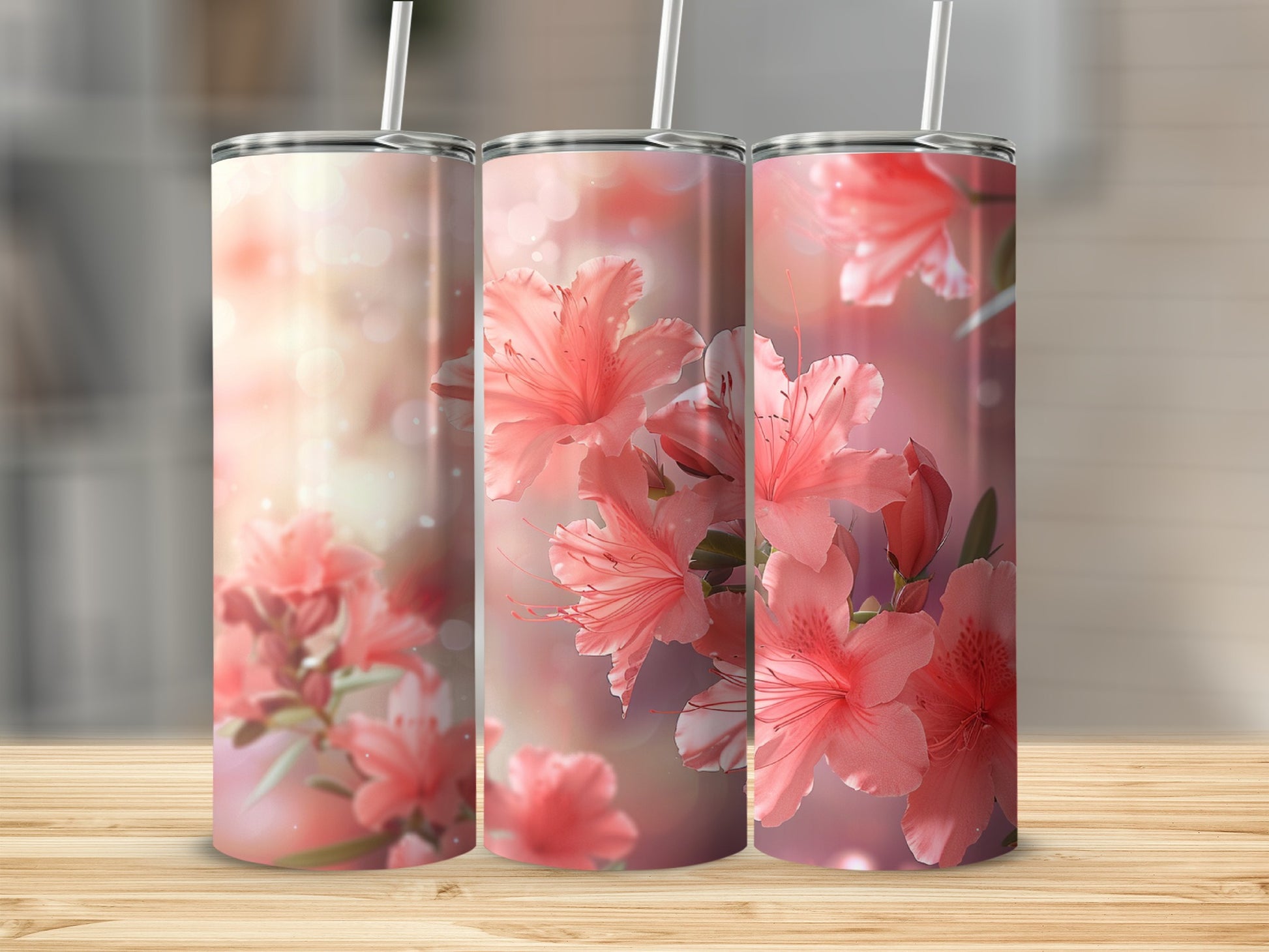 Three tumblers with coral azalea flowers and bokeh background.