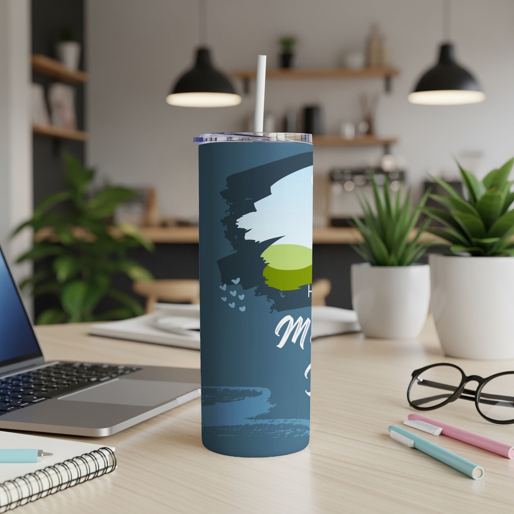 Dark blue tumbler with white text "Happy Mom" and abstract brush strokes.