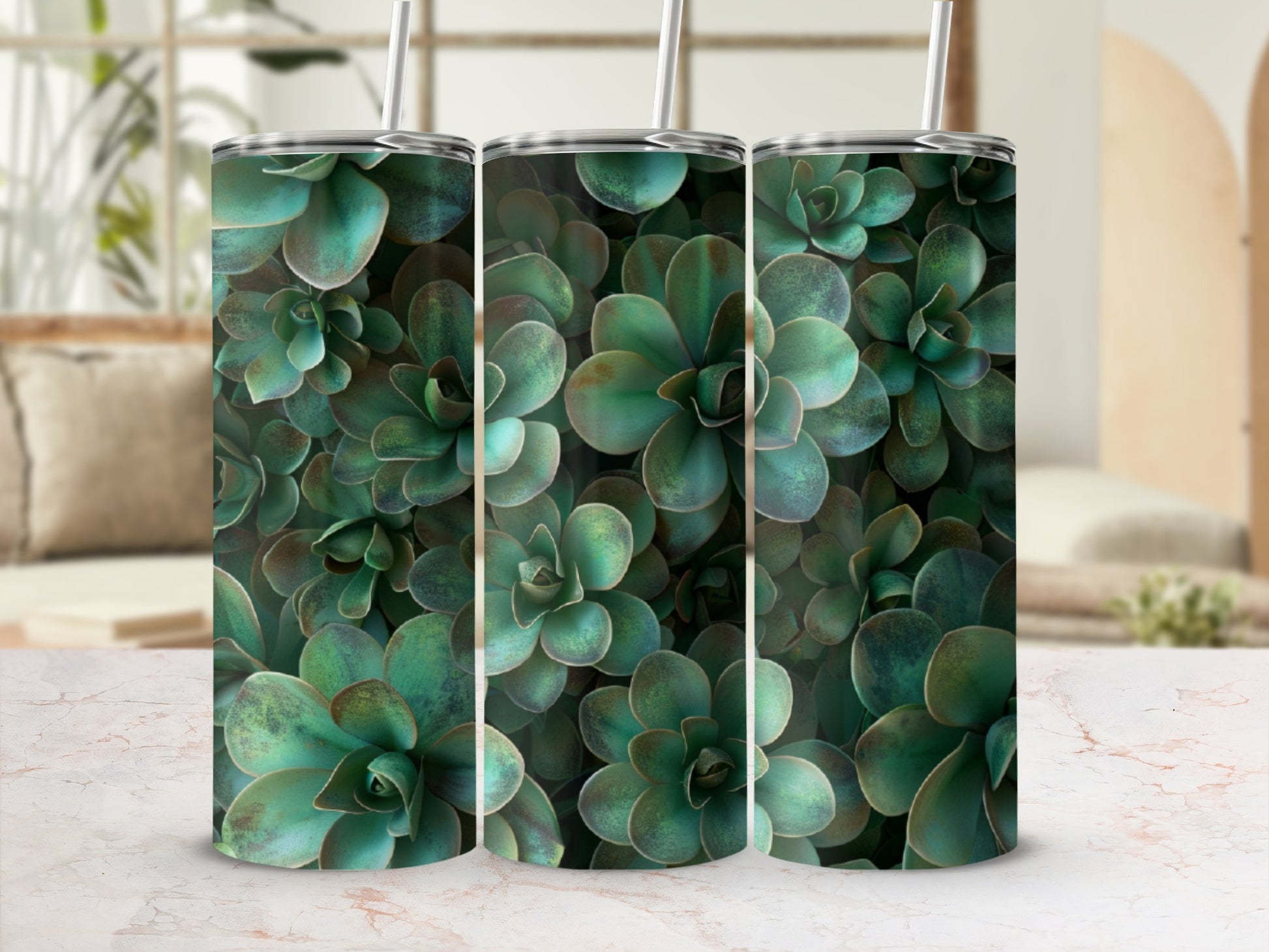 Three green succulent tumblers with straws on a marbled surface.