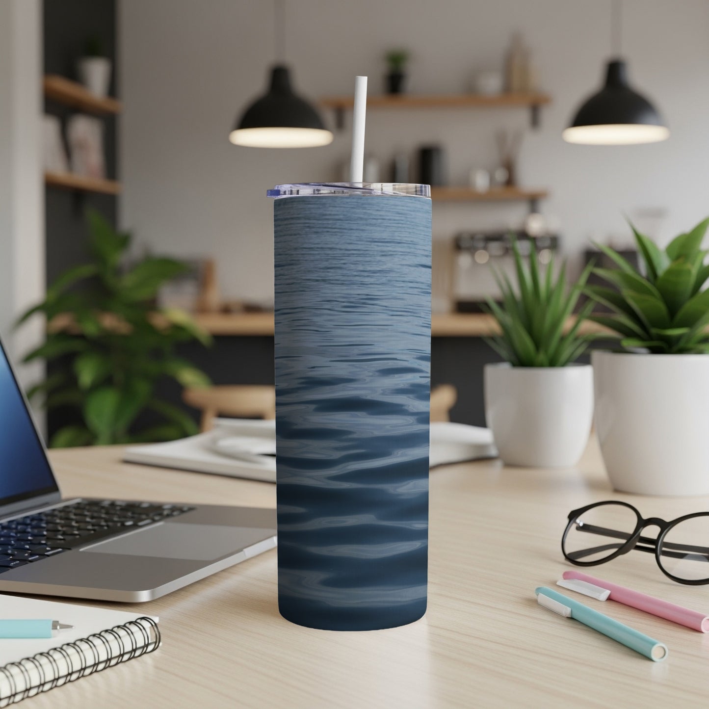 Blue wavy water pattern on a white tumbler with straw.