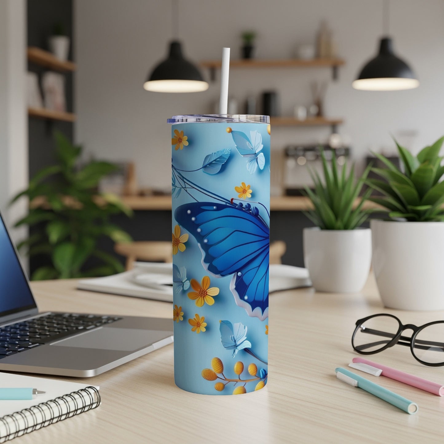 Light blue tumbler with blue butterfly and floral design.