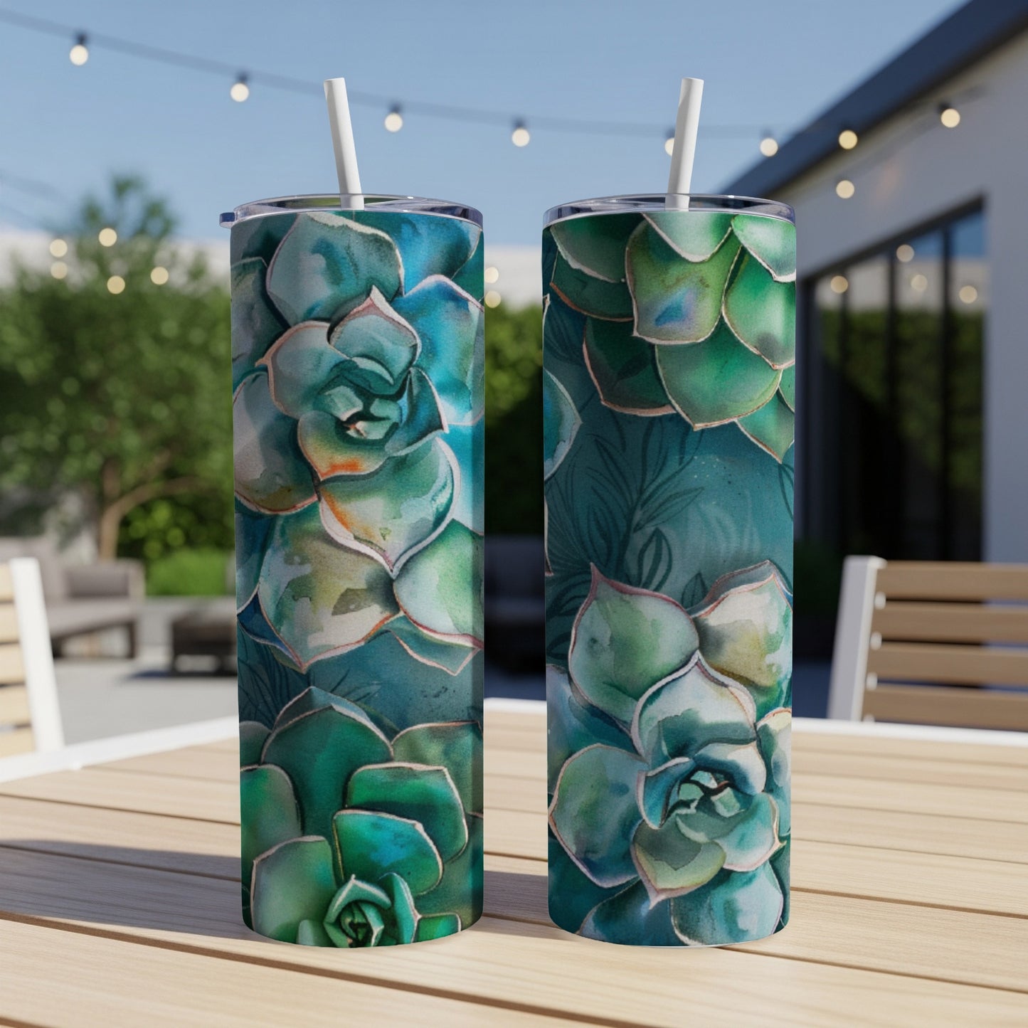 Two tumblers with detailed watercolor succulent designs on a wooden table.